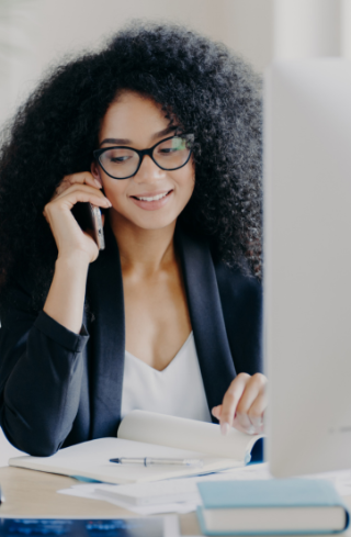 Jeune femme au téléphone prenant des notes